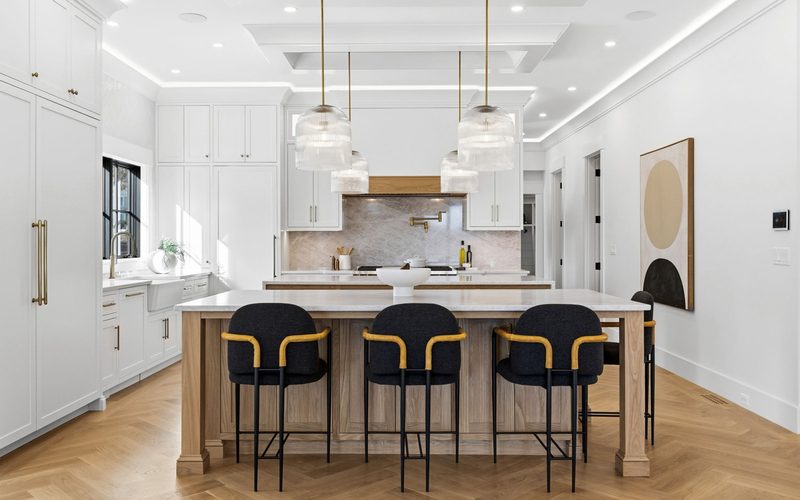 Luxury smart home kitchen with automated lighting and coffered ceiling